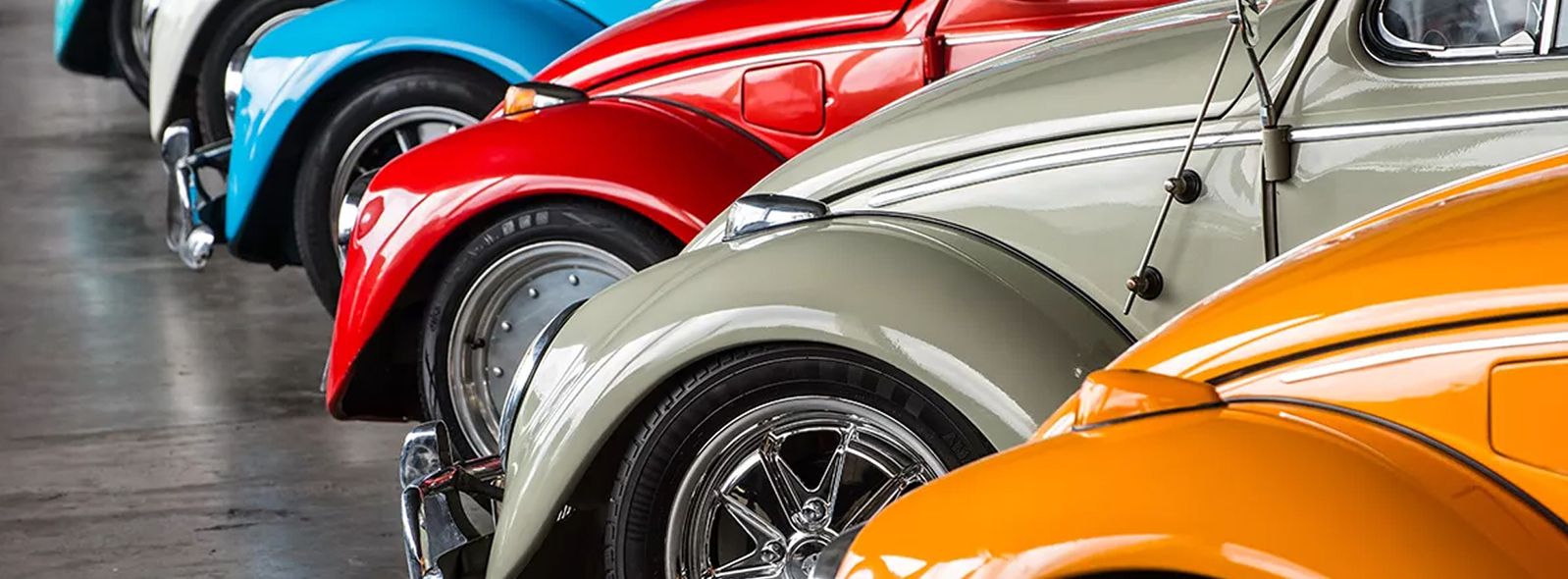 Reihe von klassischen Volkswagen Käfer in verschiedenen Farben von der Seite fotografiert